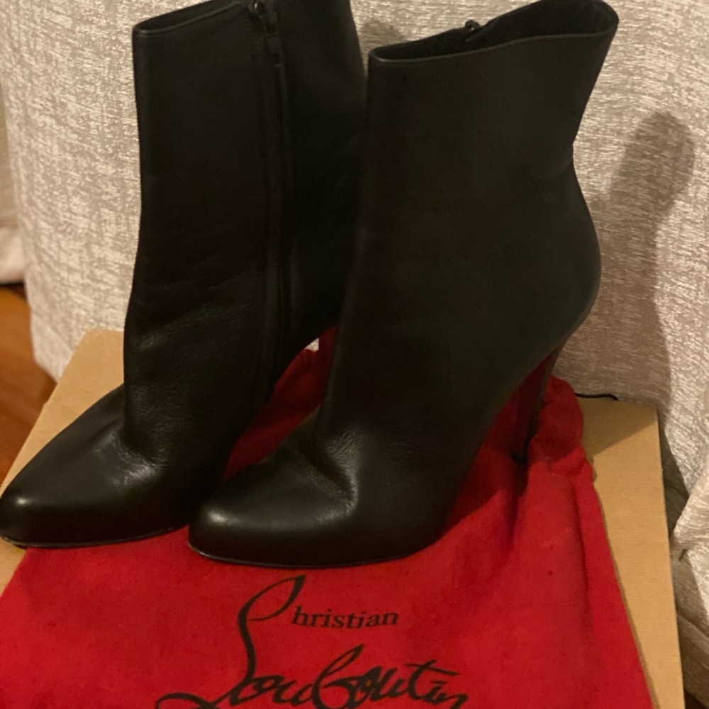 Louboutin black boot. Hits above ankle about low calf.